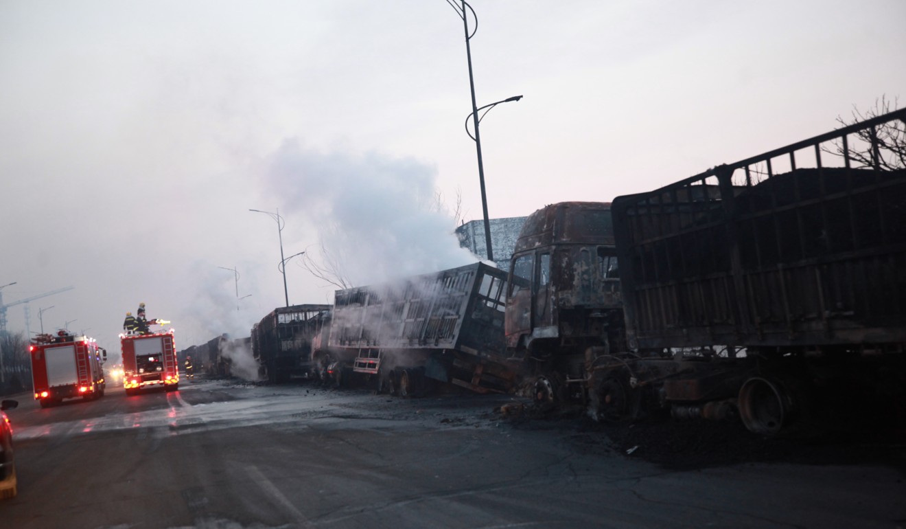 A row of trucks reveals some of the damage after the explosion overnight. Photo: Xinhua