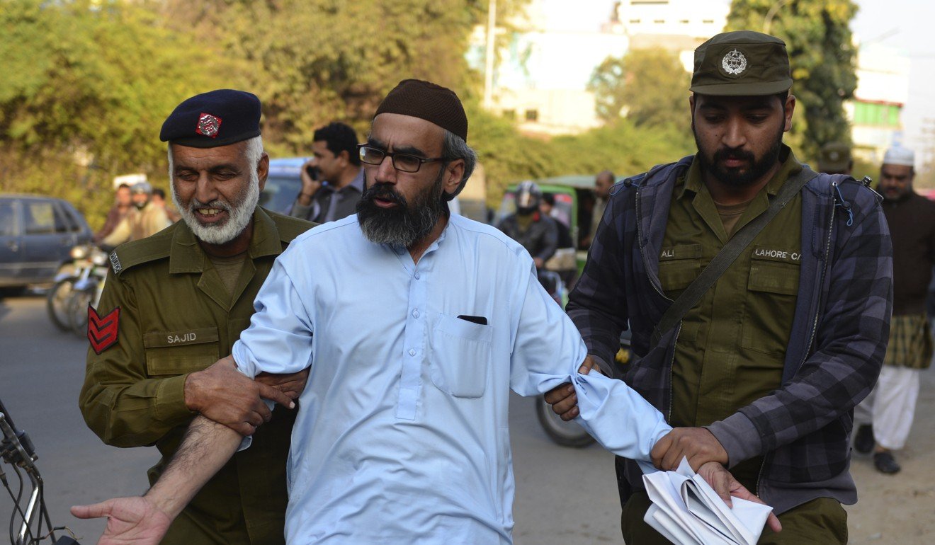 Police officers arrest a supporter of Pakistani religious group Tehreek-e-Labbaik. Photo: AP