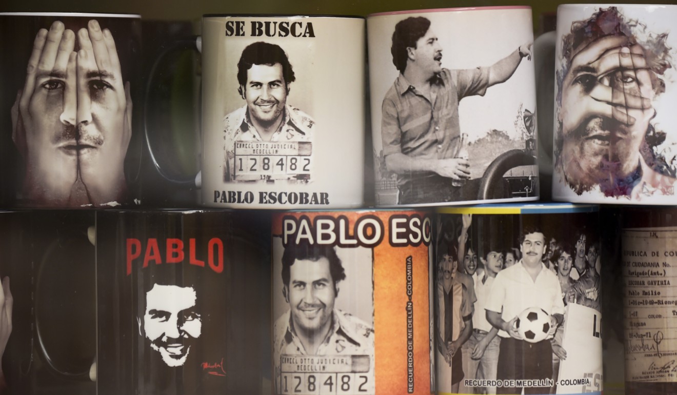 View of souvenirs with the image of the late Colombian drug lord Pablo Escobar for sale in a hairdresser’s at Pablo Escobar neighborhood. Photo: AFP