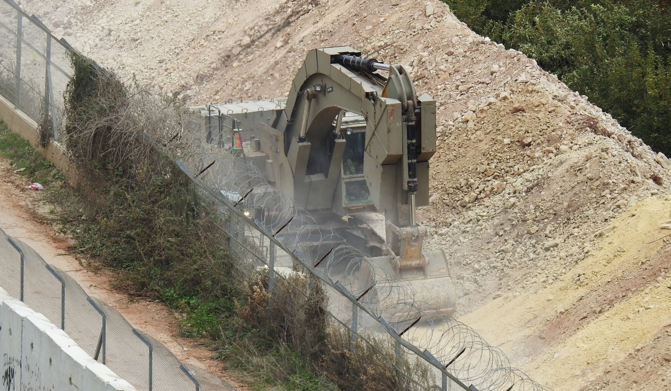 An Israeli vehicle digging along the border. Photo: Reuters