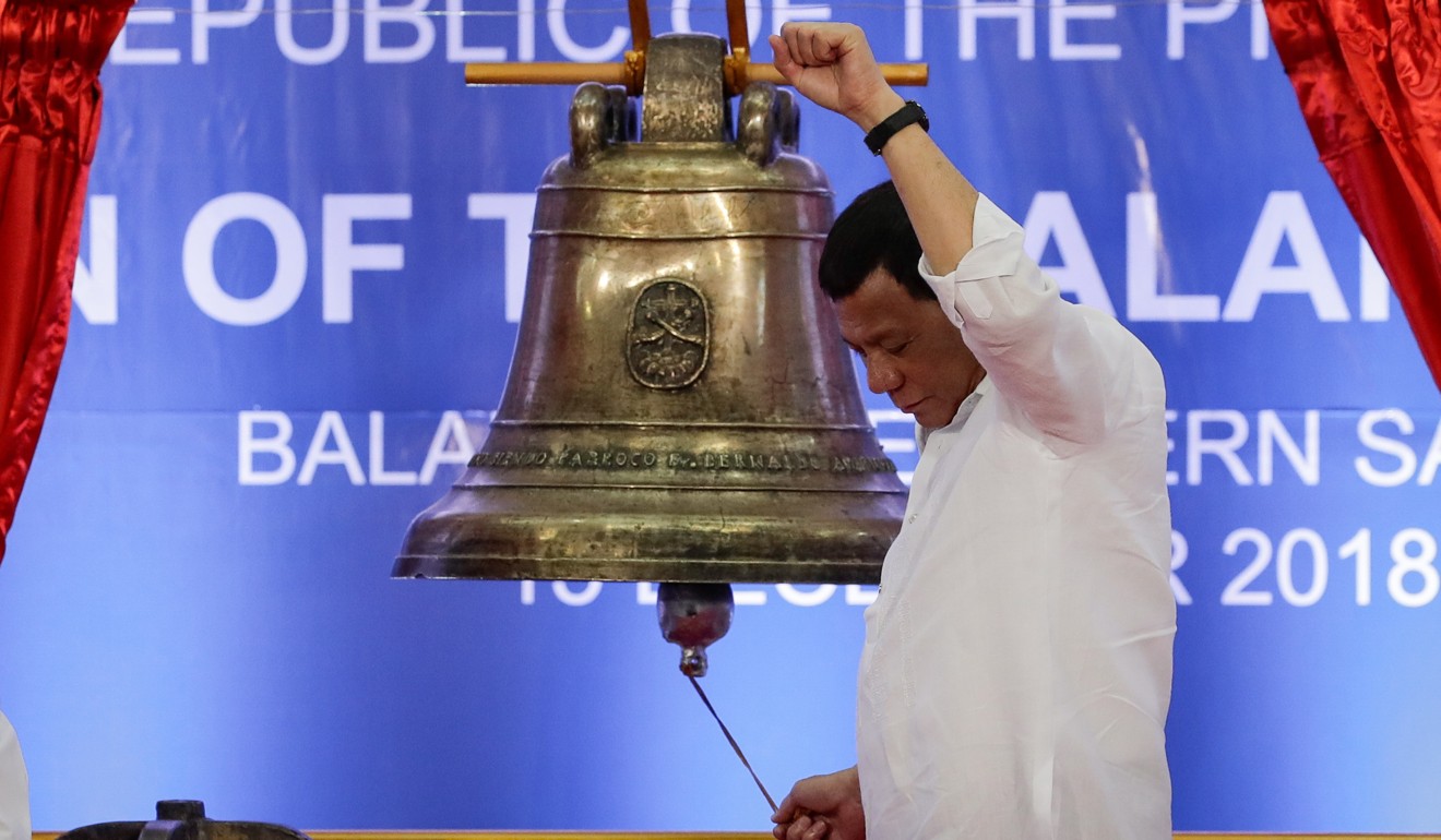 President Rodrigo Duterte rings one of the Balangiga Bells during a handover ceremony in Balangiga, Eastern Samar province, on December 15. After more than a century, the Balangiga Bells were returned to the Philippines after being taken by US forces from Balangiga as spoils of war in 1901. Photo: EPA-EFE