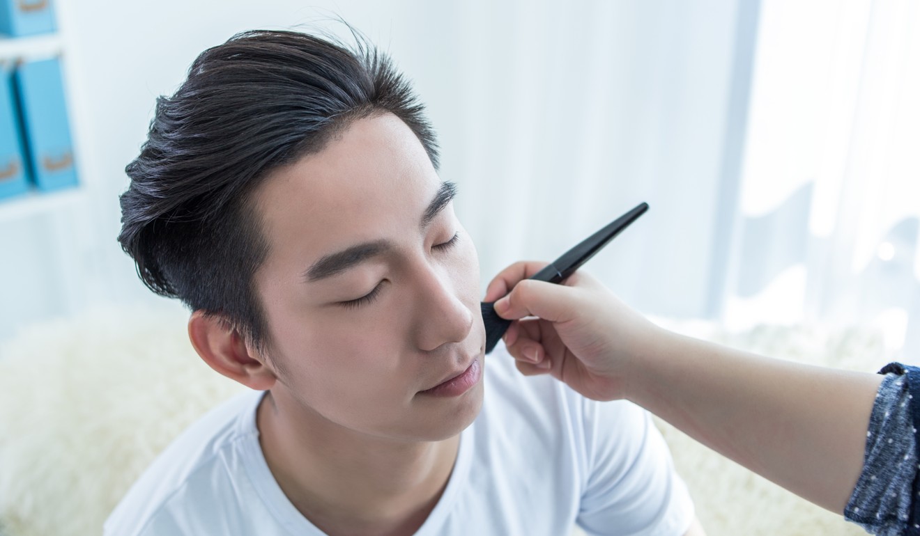 A Chinese man has make-up applied. Photo: Handout