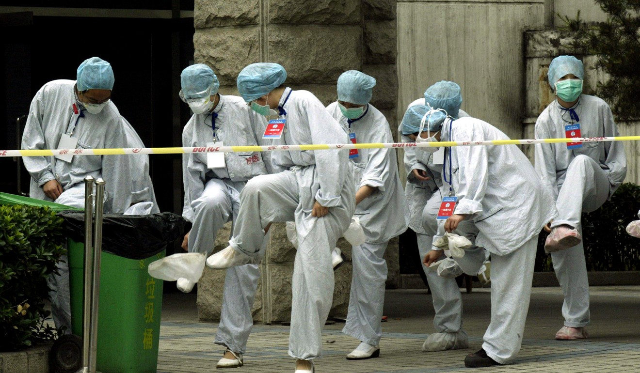 A group of nurses at a Beijing hospital remove their shoe coverings at the end of a shift during the Sars outbreak, in May 2003. Picture: SCMP