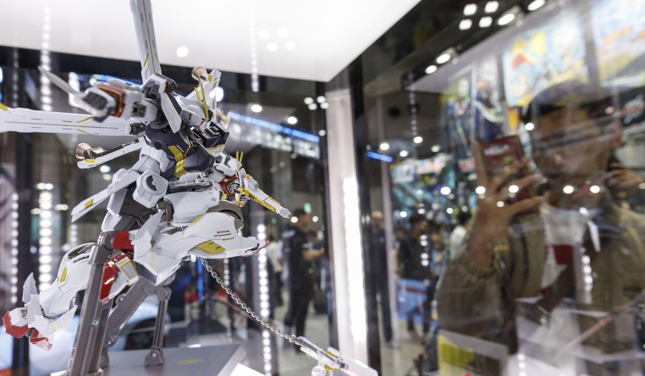 A visitor takes a picture of a Metal Build action figure. Photo: Rodrigo Reyes Marin/Zuma Wire/Alamy