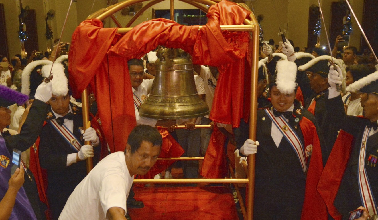 A church bell taken by American troops more than a century ago is brought inside Balangiga Church after a formal handover ceremony. Photo: AP