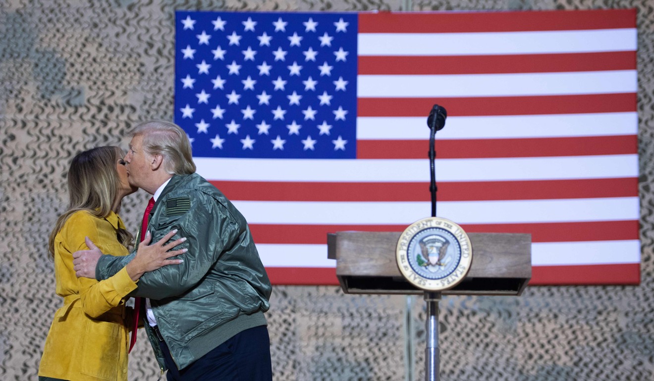US President Donald Trump kisses first lady Melania Trump during his unannounced trip to Al-Asad Air Base in Iraq. Photo: AFP