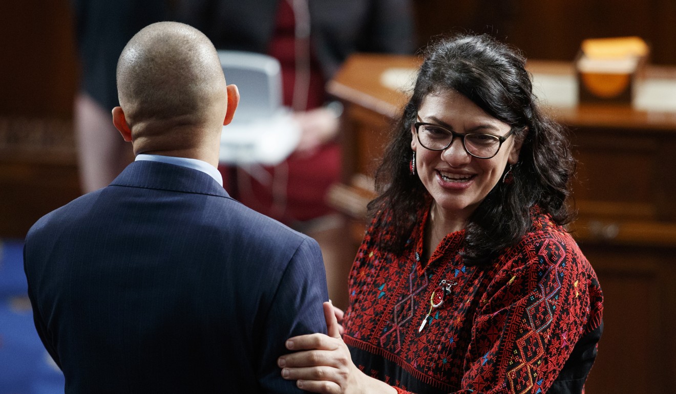 Rashida Tlaib of Michigan stands with with Hakeem Jeffries on the house floor before they were sworn into the 116th Congress at the US Capitol in Washington. Photo: AP