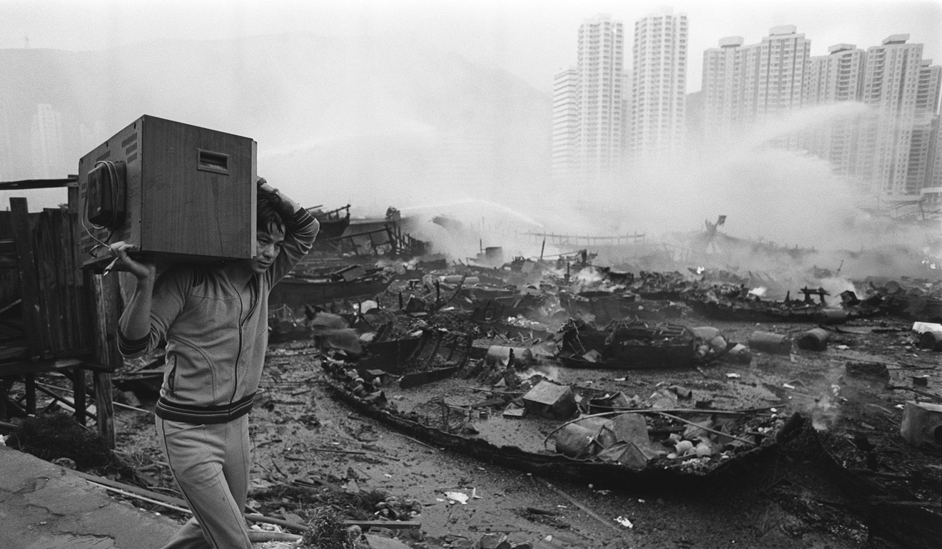 A resident evacuates with his television from a fire at Ap Lei Chau Typhoon Shelter. Photo: SCMP Archive