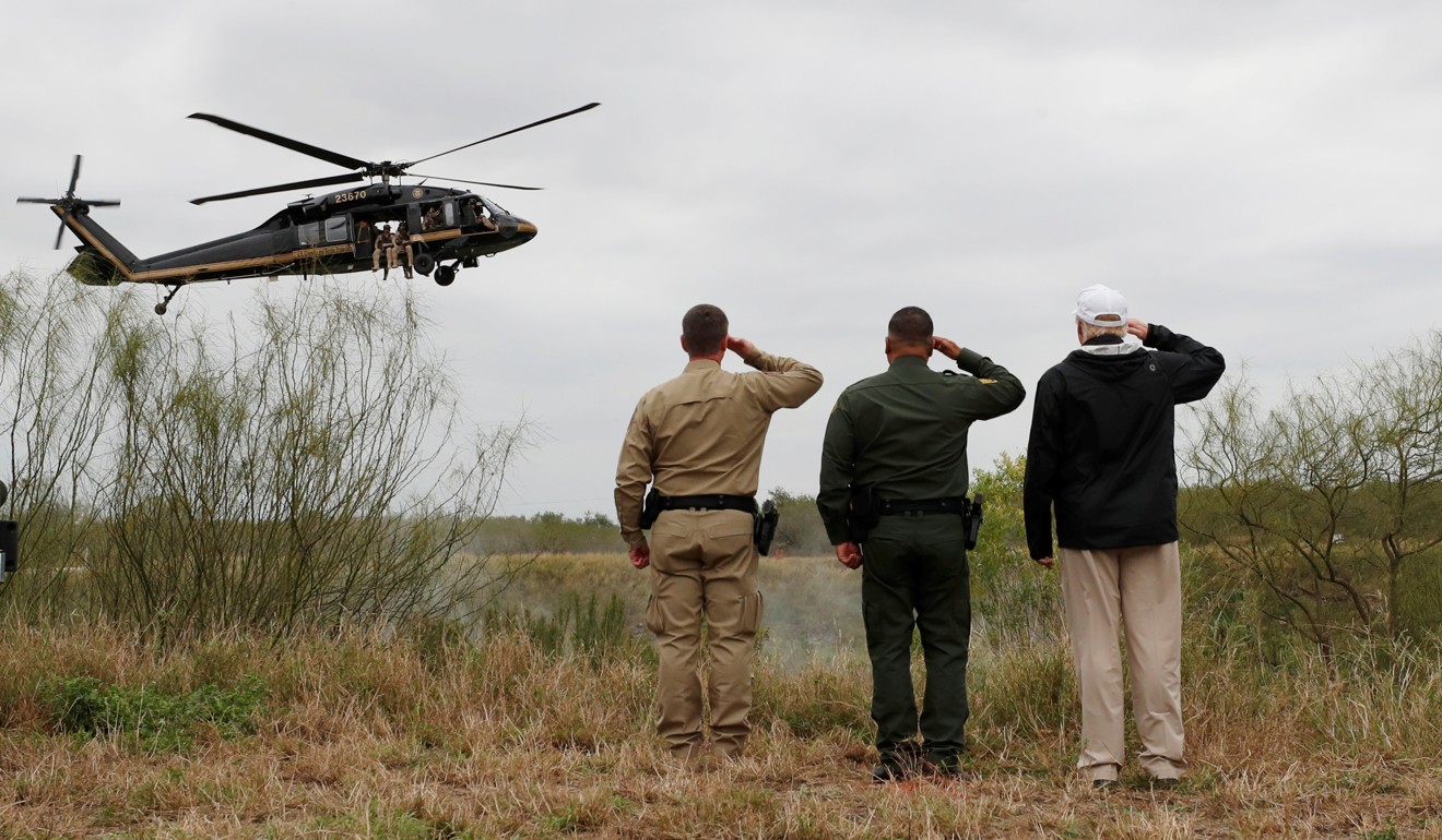 President Donald Trump (right) salutes a US Border Patrol helicopter with US Border Patrol during his visit to the US- Mexico border in Mission, Texas on Thursday. Photo: Reuters