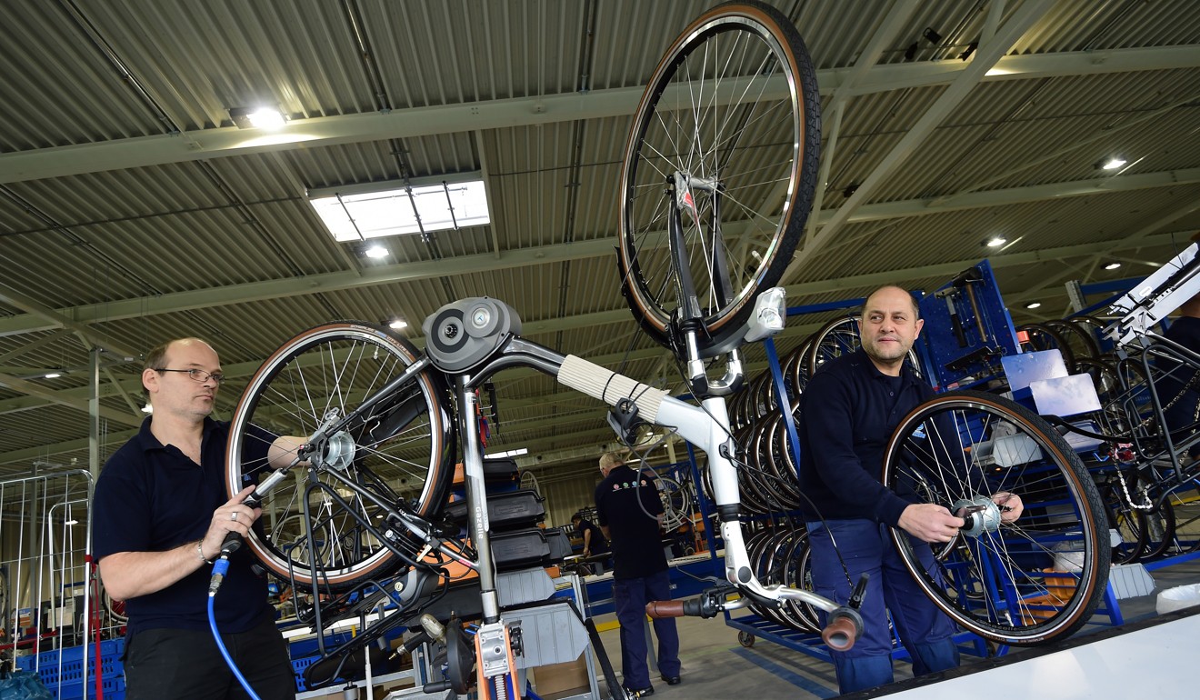 Workers produce electric bicycles at the factory of Dutch bicycle manufacturer Gazelle in Dieren, The Netherlands. Photo: AFP