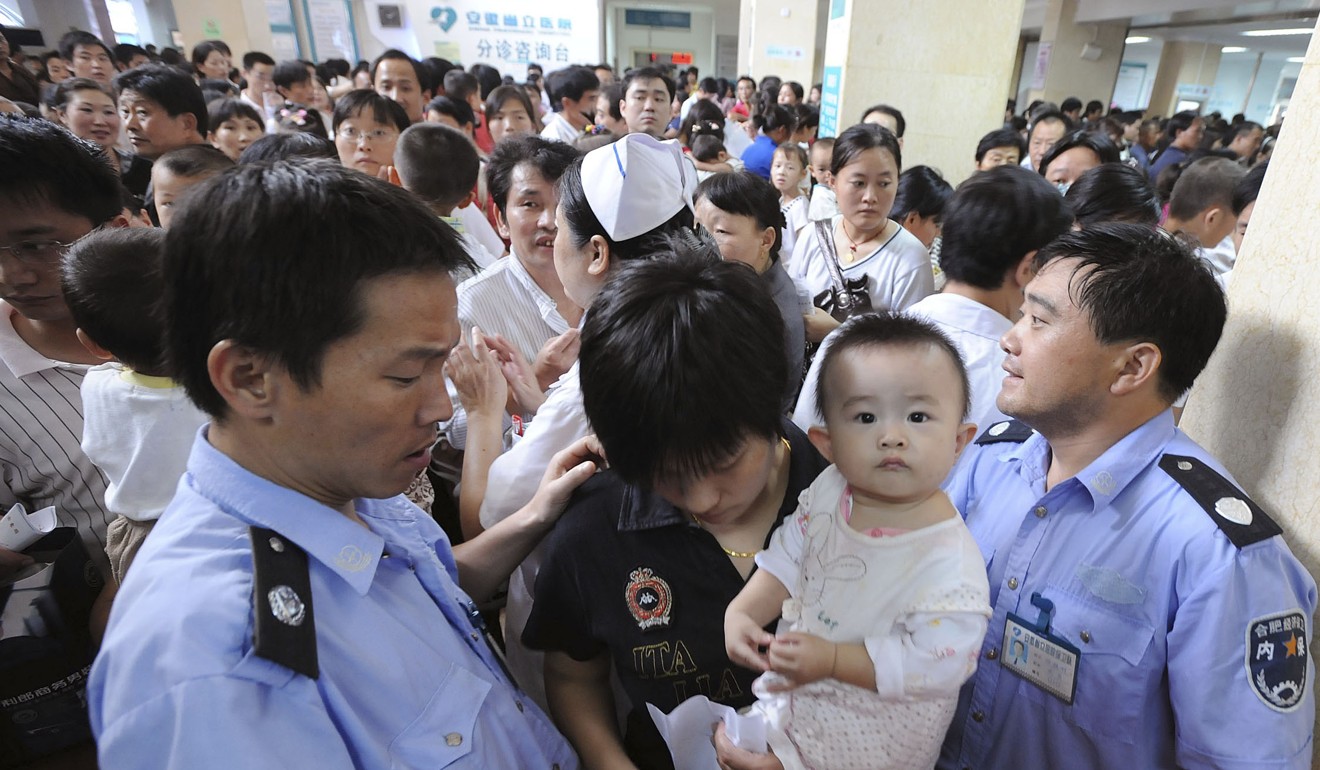 Parents and children await medical checks at a hospital in Hefei after nearly 10 per cent of milk samples from three top Chinese dairy companies were found to contain melamine. Photo: Reuters