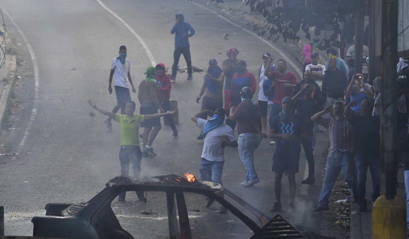 People protest around the Cotiza Bolivarian National Guard headquarter in Caracas, during a military coup against Maduro. Photo: AFP