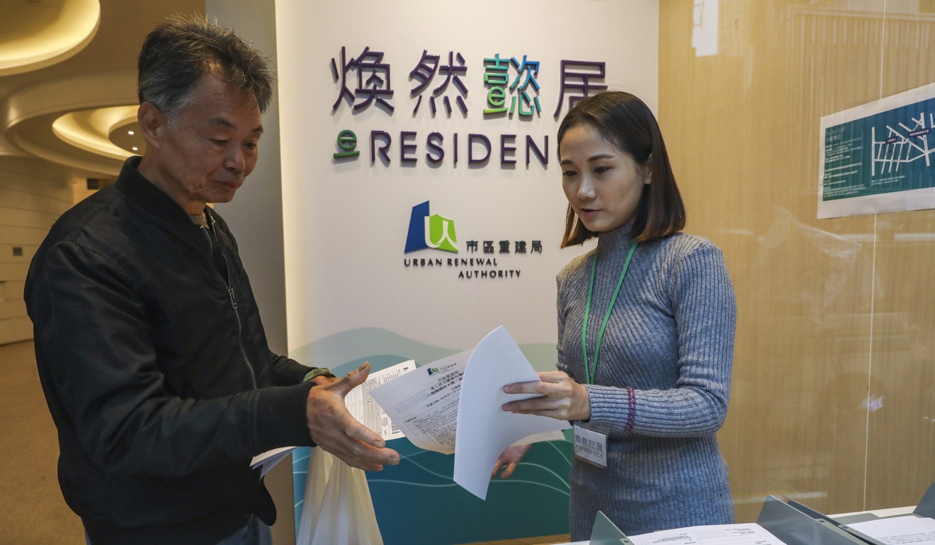 A potential buyer collects an application form for the eResidence starter homes project. Photo: Sam Tsang