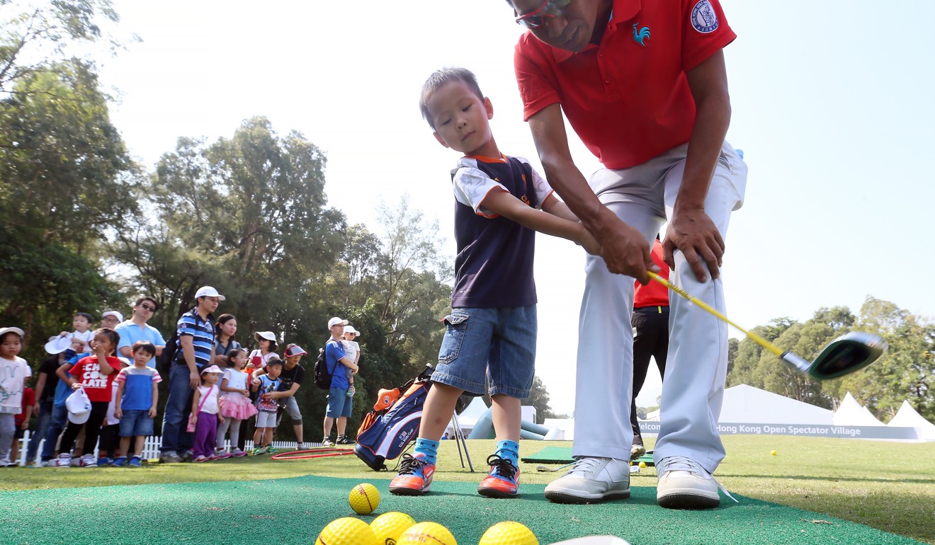 Golfers give tips to kids on the free practice day ahead of the Hong Kong Open, at the Hong Kong Golf Club in Fanling in 2015. Photo: Handout