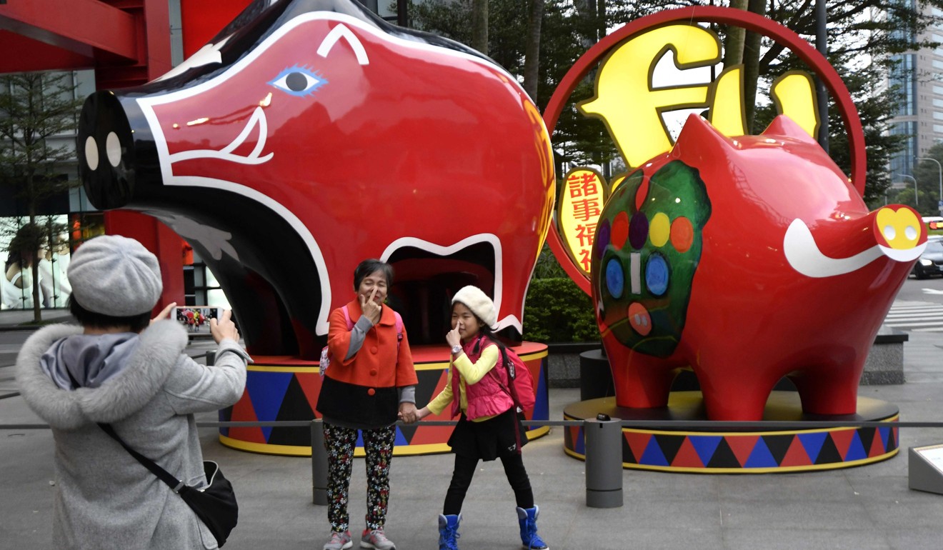 Visitors to Taipei mark the coming Year of the Pig. Photo: AFP