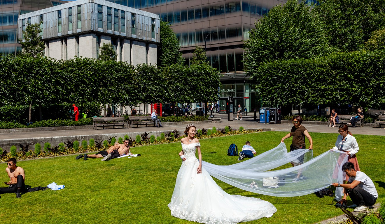 A visiting bride From Hong Kong poses on the lawns outside St Paul’s Cathedral in London. Photo: Alamy