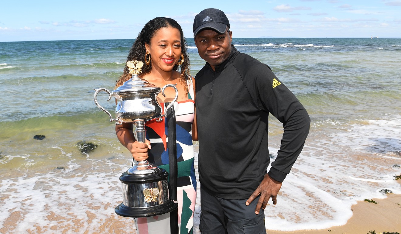 Naomi Osaka poses for a photo with her father Leonard Francois and the Australian Open trophy at Brighton Beach in Melbourne. Photo: EPA