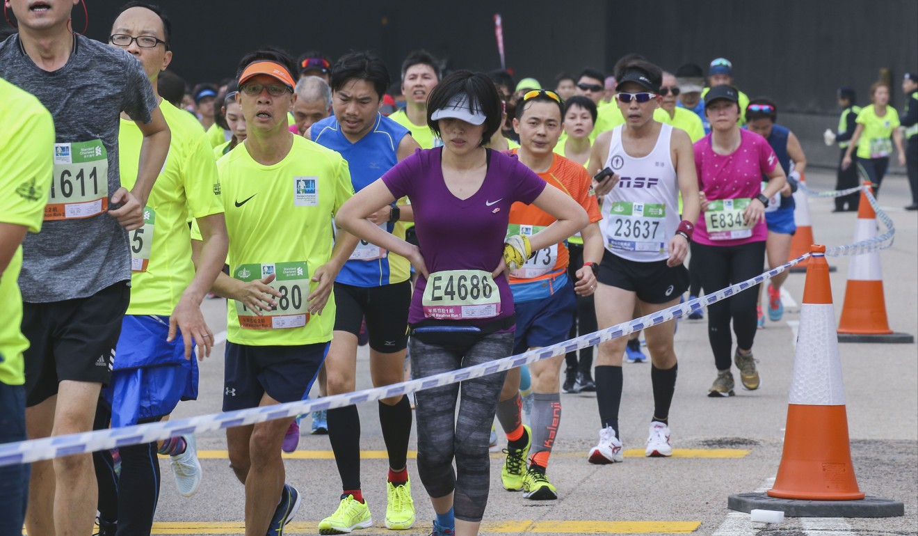 Participants run through Central district during the Standard Chartered Hong Kong Marathon. Photo: Dickson Lee
