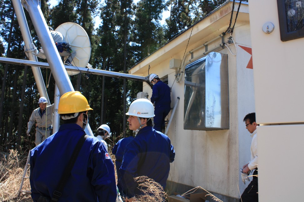 Engineers from Huawei Technologies provide disaster relief by keeping telecommunications networks up and running after the 2011 Tohoku earthquake and tsunami in Japan. Photo: Handout