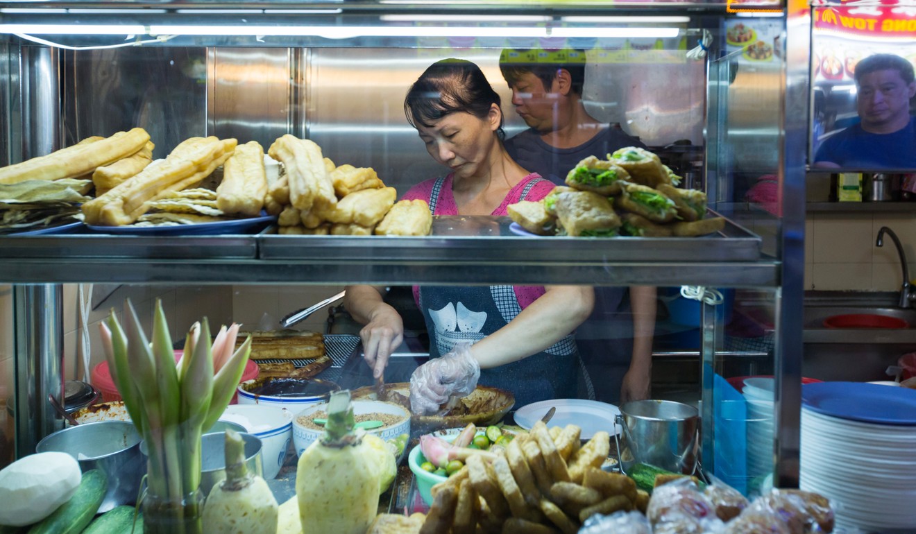 Singapore will lower the quotas for foreign workers in the services sector to boost productivity in food and retail businesses. Photo: Bloomberg
