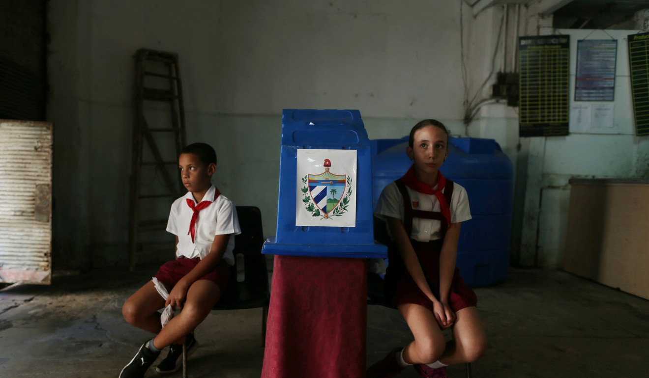 Children wait for voters at a polling station during a constitutional referendum in Havana. Photo: Reuter