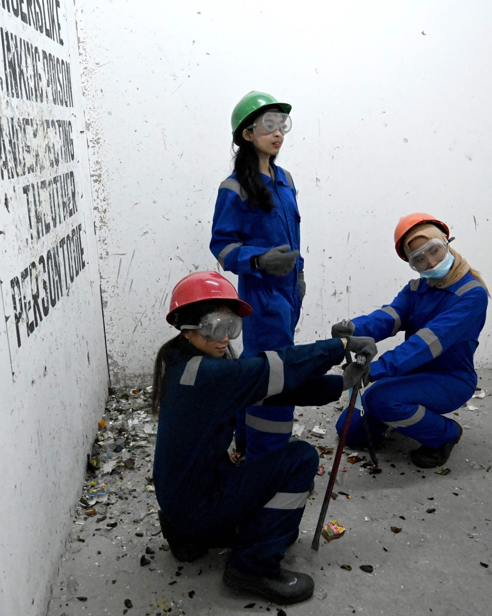 Three women survey the damage after their bust-it-up session at the Jakarta Temper Clinic. Photo: AFP