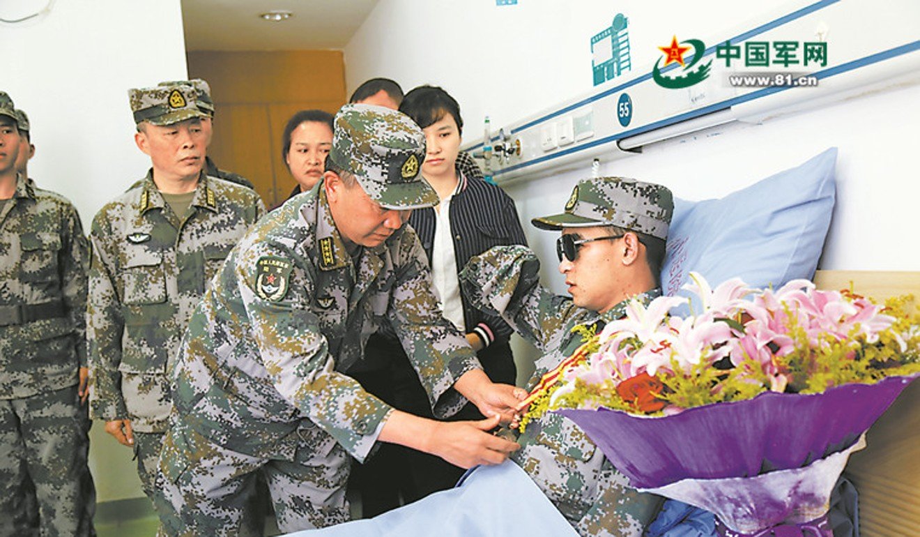 Du Fuguo receives his first-class medal in hospital. Photo: Handout