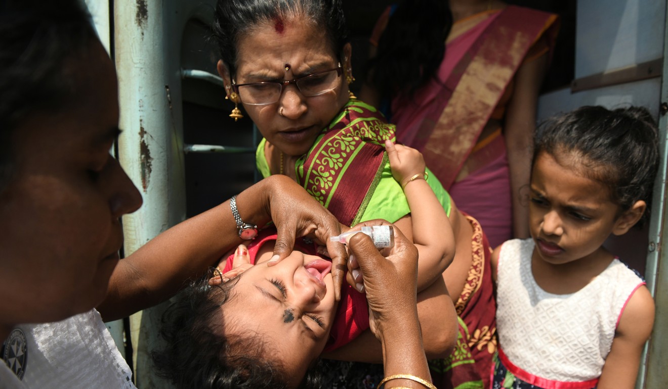 An Indian health official administering polio vaccine drops at a railway station in Chennai. Photo: AFP