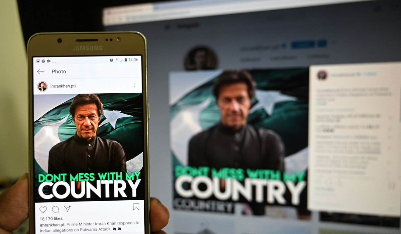 A man looks at an image of Pakistani Prime Minister Imran Khan on his official Instagram account. Photo: AFP