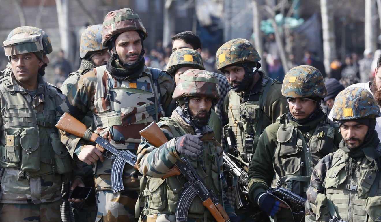 Indian soldiers stand near the wreckage of an Indian helicopter after it crashed on the outskirts of Srinagar, Indian-controlled Kashmir. Photo: AP