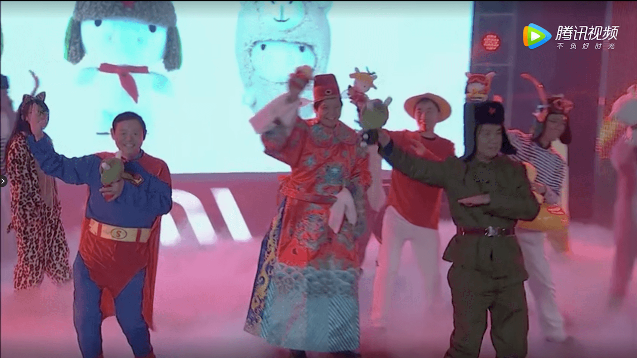 Lei (center, in red) follows the tradition of many Chinese billionaires who like to put on extravagant shows during office parties. (Picture: Xiaomi/Tencent Video)