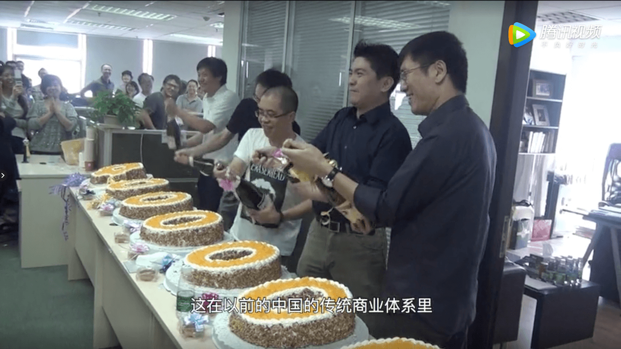 Lei (left, in white shirt) and his team celebrate the sale of 4 million handsets within nine months in 2012. (Picture: Xiaomi/Tencent Video)