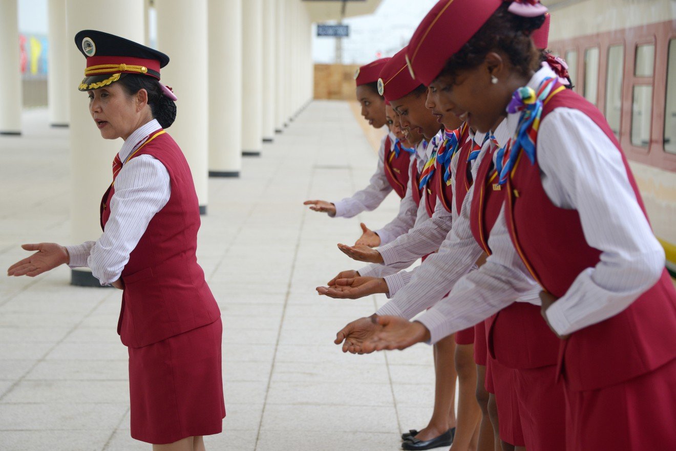 A Chinese rail conductor trains Ethiopian attendants at a railway station in Ethiopia in 2016. China built a railway linking the Ethiopian capital of Addis Ababa and the port of Djibouti as part of the Belt and Road Initiative. 