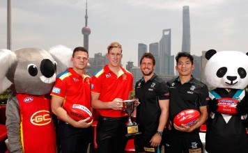 Steven May of the Suns, Tom Lynch of the Suns, Travis Boak of the Power and Chen Shaoliang of the Power pose for a photograph with the 2017 Shanghai Cup during the Port Adelaide Power and Gold Coast Suns joint Captain and Coach press conference at Bar Rouge overlooking The Bund on May 11, 2017 in Shanghai, China. (Photo by Michael Willson/AFL Media)