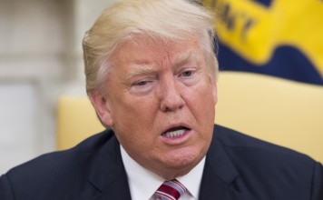 U.S. President Donald Trump speaks to members of the media while meeting with Henry Kissinger, former Secretary of State, not pictured, in the Oval Office of the White House in Washington, D.C., U.S., on Wednesday, May 10, 2017. Trump, sitting alongside Henry Kissinger, told members of the media that he was speaking with Kissinger on Russia, Syria and "other matters." Photographer: Molly Riley/ Pool via Bloomberg