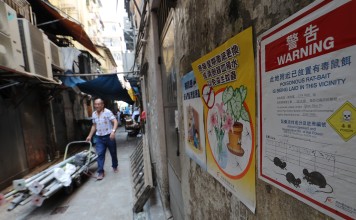 A government notice posted in a Hong Kong alleyway warns of rat poison in the area. Photo: Edward Wong