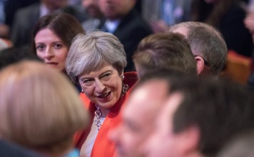 Theresa May, UK prime minister, reacts as she sits in audience during the Conservative Party annual conference in Birmingham, UK, on Sunday, September 30, 2018. May is battling to assert her authority as UK prime minister after a disastrous start to her party’s annual conference threatened to explode into a full-blown leadership crisis. Photographer: Chris Ratcliffe/Bloomberg