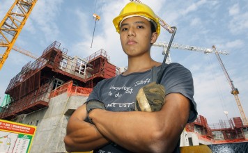 Yeung Wai-yip, an university graduate who became a bar-bender, poses for a photo at a construction site in Hung Shui Kiu. Hong Kong society has been accused of looking down on blue-collar labourers, even though the city needs them and they can make more money than some university graduates. Photo: Edward Wong