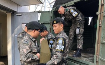 South Korean soldiers carry military equipment before leaving the Joint Security Area on Thursday. Photo: EPA