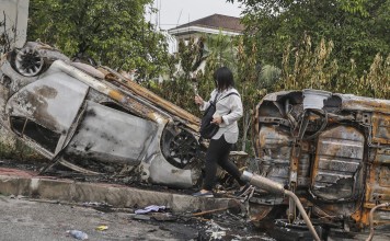 A burnt car that was flipped upside down during the riot at the Sri Maha Mariamman Temple in Subang Jaya, Selangor, outside Kuala Lumpur, Malaysia. Photo: EPA