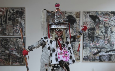 Frog King (Kwok Mang-ho), conceptual artist, poses for a photograph in front of his recent works at 10 Chancery Lane Gallery in Central. 01DEC15 [2015 FEATURES ARTS] SCMP / BRUCE YAN