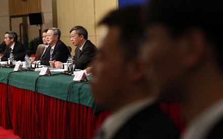 Central bank governor Zhou Xiaochuan (third from left) speaks to reporters during a press conference on the sidelines of the National People’s Congress meeting. For the first time, he publicly condemned exuberant overseas deal-making by Chinese firms, further justifying China’s capital controls. Photo: EPA