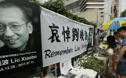 Mourners place offerings at a memorial for Liu Xiaobo outside the central government’s liaison office in Hong Kong on July 15. Liu died of liver cancer on July 13. Photo: Edward Wong