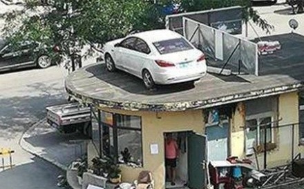 The car was left on the roof of the security station after the dispute between its driver and the residential estate’s security guards. Photo: Handout The car was left on the roof of the security station after the dispute between its driver and the residential estate’s security guards. Photo: Handout