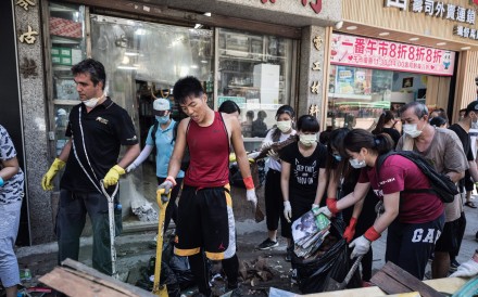 Local residents clean debris and rubbish on a street in the aftermath of Typhoon Hato in Macau. Photo: AFP Photo Local residents clean debris and rubbish on a street in the aftermath of Typhoon Hato in Macau. Photo: AFP Photo