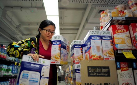 Chinese daigou shopping agent Na Wang selects an Australian breakfast cereal product during a shopping trip for Chinese customers at an Australian supermarket in Sydney. Photo: Reuters
