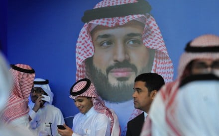 Saudi men chat in front of a poster of Saudi Crown Prince Mohammed bin Salman during the MiSK Global Forum held under the slogan Meeting the Challenge of Change in Riyadh, in November. Photo: AFP