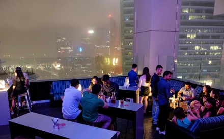 Guests enjoy drinks at the Skyline bar overlooking Singapore’s financial district. Photo: AFP