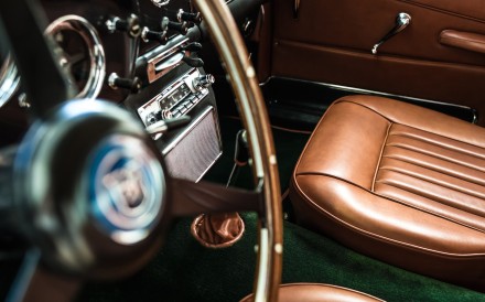The interior of an Aston Martin DB4 in gold calfskin and rug in English green New Zealand wool, customised by Hermès.