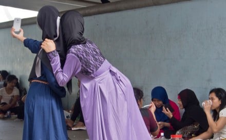 With no facilities designed for their use, domestic helpers head to public places to relax on their day off – and they’re not always welcome